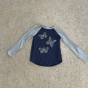 Girls long sleeve shirt with butterfly design. Size: L (10-12).